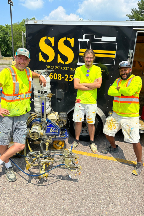 Group Photo Of Employees With Lot Painting Machinery
