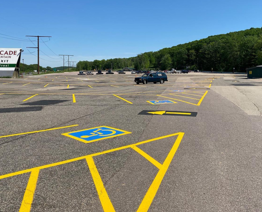 Painted Parking Lot In Front Of Cascade Mountain Sign
