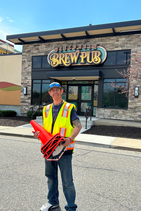 Ssi Employee Smiling In Front Of Wisconsin Brew Pub