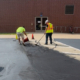 Two Ssi Workers Repairing Cracks In Parking Lot