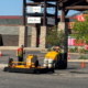 Workers Filling Pothole In Outlet Mall Parking Lot